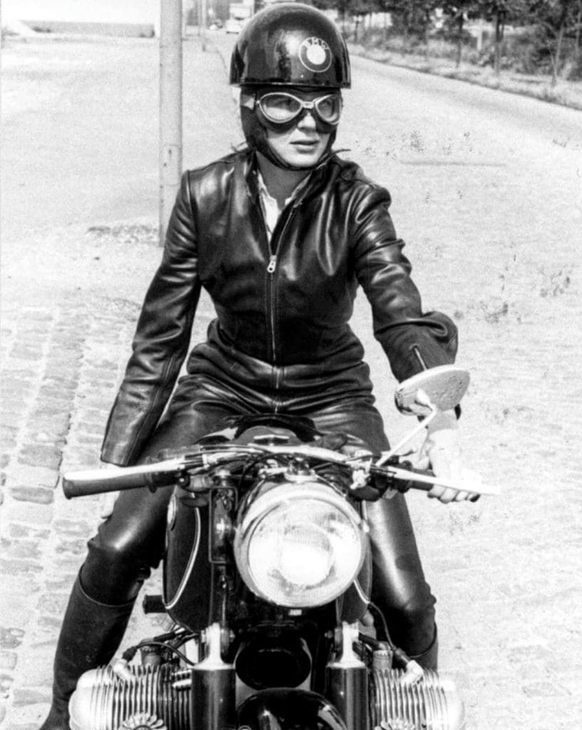 Anke-Eve Goldmann in her catsuit, photographed on the Nurburgring track on her BMW R69, 1962.